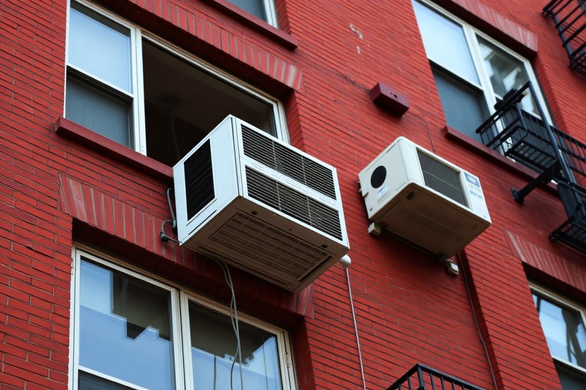 Window air conditioners on a New York City apartment building facade