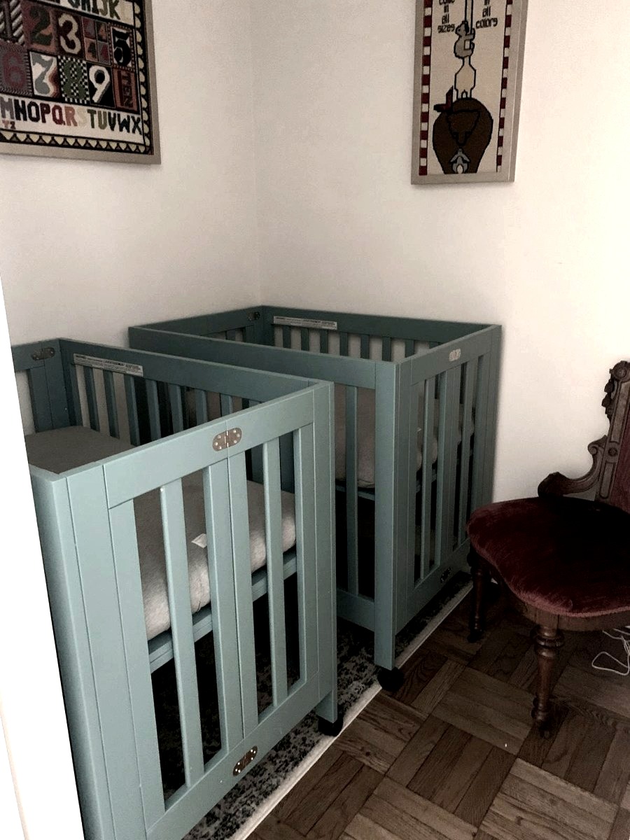 Two folding cribs set up inside a closet in a New York City apartment