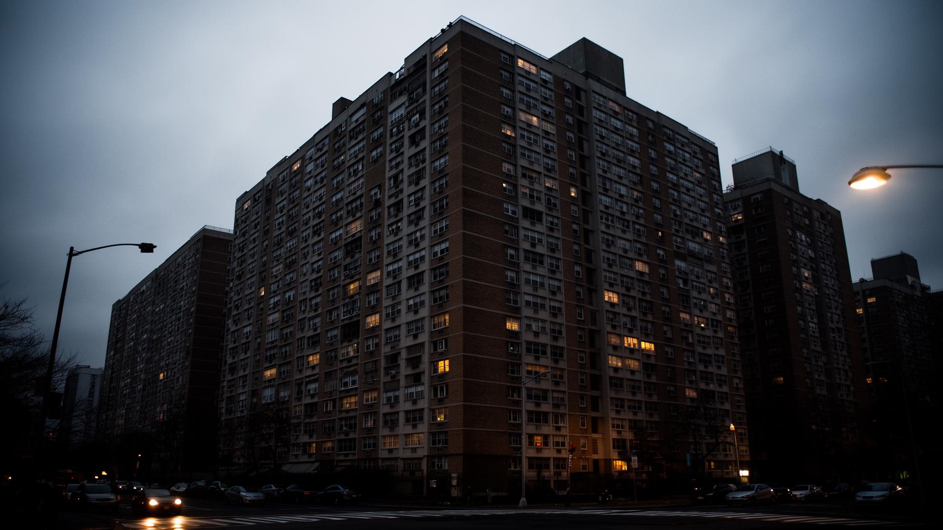Richman Plaza, a large Bronx residential high-rise at dusk with scattered lit windows
