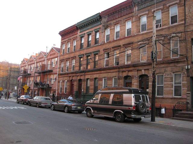 Weathered brick tenement buildings on a Mott Haven street in the Bronx — the kind of rent-stabilized walk-ups dominated by New York's worst-ranked landlords.